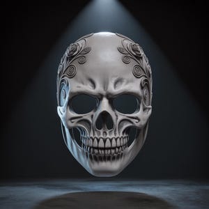 May include: A gray skull mask with intricate floral designs on the forehead. The mask has large eye sockets and a detailed jawline. The mask is illuminated by a spotlight against a dark background.