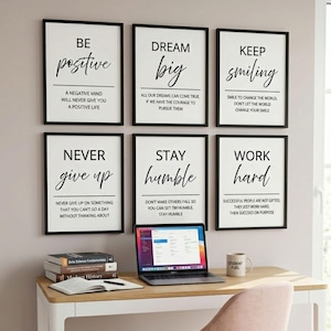 May include: Six framed wall art prints with black frames and white backgrounds, each featuring motivational text in black serif and script fonts. The prints display phrases like Be Positive, Dream Big, Keep Smiling, Never Give Up, Stay Humble, and Work Hard.
