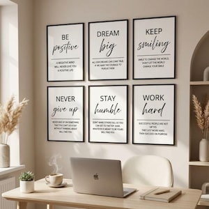 May include: A set of six rectangular wall art prints with black frames, each featuring white backgrounds and black text. The prints display motivational phrases including Be Positive, Dream Big, Keep Smiling, Never Give Up, Stay Humble, and Work Hard.