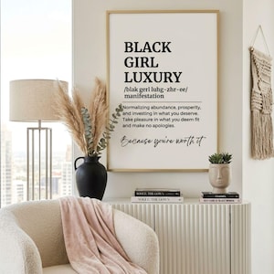 May include: A framed wall art print featuring the text BLACK GIRL LUXURY, a phonetic pronunciation, and a definition about abundance and prosperity. The print includes the phrase Because you're worth it in a script font, all in black on a white background.
