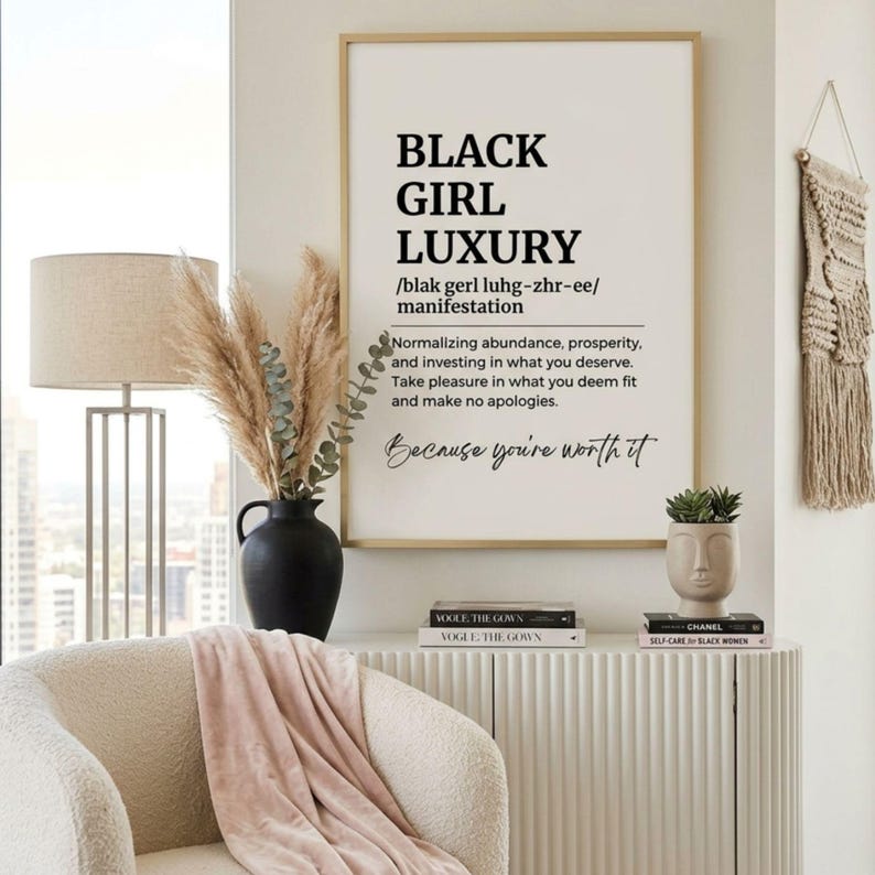 May include: A framed wall art print featuring the text BLACK GIRL LUXURY, a phonetic pronunciation, and a definition about abundance and prosperity. The print includes the phrase Because you're worth it in a script font, all in black on a white background.
