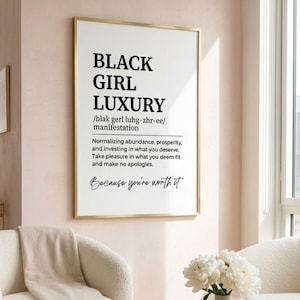May include: A vertical rectangular wall art print in a thin gold frame featuring the black text BLACK GIRL LUXURY, a phonetic pronunciation guide, and a definition about normalizing abundance, prosperity, and investing in what you deserve.