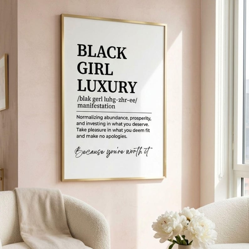 May include: A vertical rectangular wall art print in a thin gold frame featuring the black text BLACK GIRL LUXURY, a phonetic pronunciation guide, and a definition about normalizing abundance, prosperity, and investing in what you deserve.