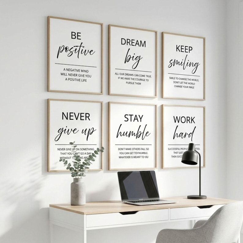 May include: A set of six rectangular wall art prints with white backgrounds and black text featuring motivational phrases including Be Positive, Dream Big, Keep Smiling, Never Give Up, Stay Humble, and Work Hard, arranged in two rows of three.