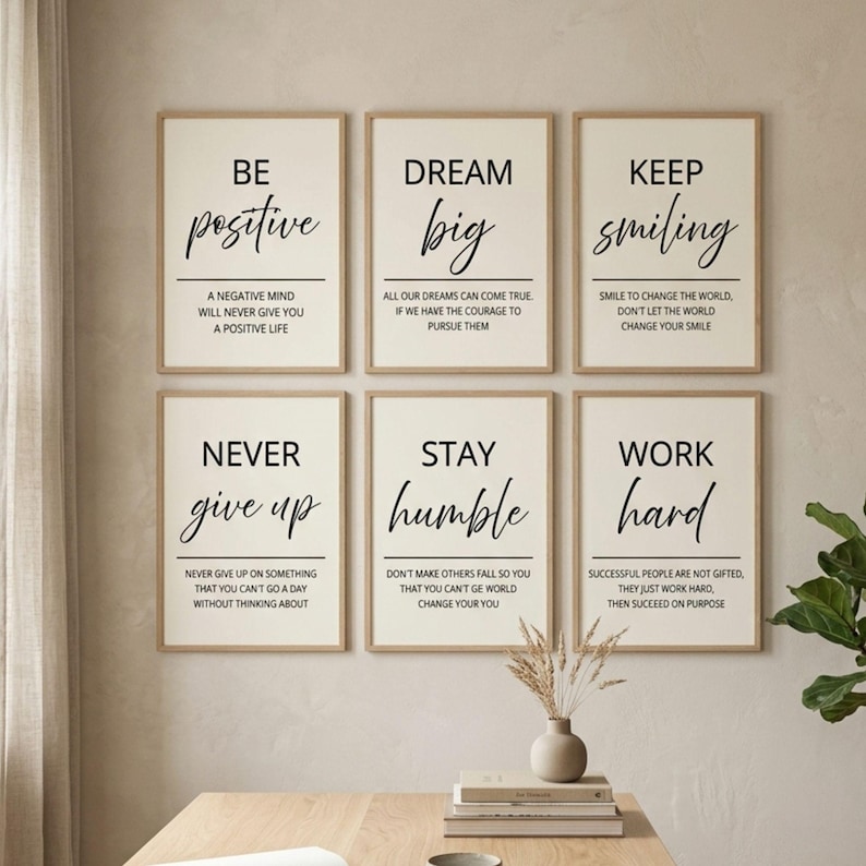 May include: A set of six rectangular wall art prints in light wood frames, each featuring black text on a cream background with motivational quotes including Be positive, Dream big, Keep smiling, Never give up, Stay humble, and Work hard.