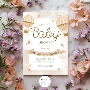 May include: Baby shower invitation with a beige background, featuring two hot air balloons and star accents. The text reads "Baby Shower" and "Honoring Jonathan Patterson". Includes date, time, location, and RSVP information.