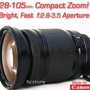 May include: A black 28-105mm compact zoom lens with a bright f/2.8-3.5 aperture. The lens has a ridged focus ring and the text "Made for Canon". The lens is designed for photography.