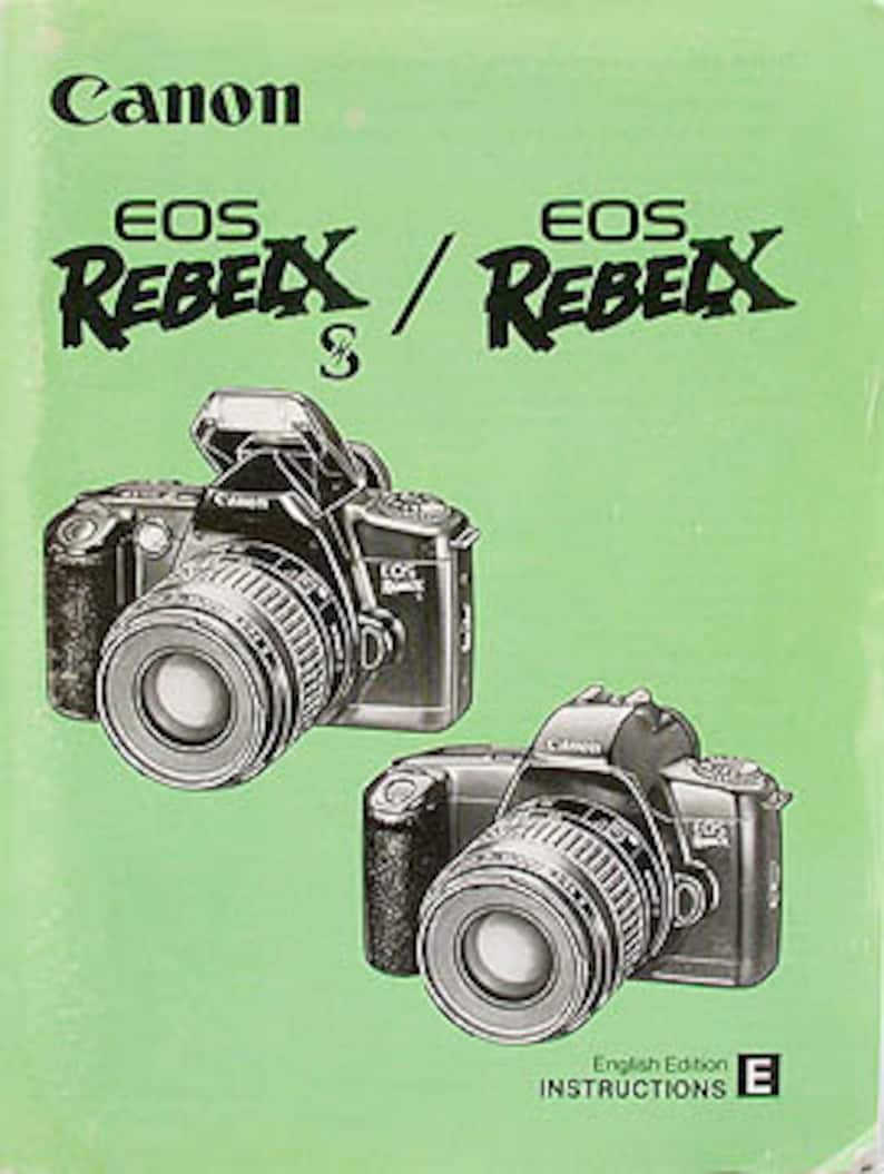 May include: Canon EOS Rebel XS and EOS Rebel X camera instruction manual with a green cover. The manual has the text "English Edition" and "INSTRUCTIONS E" on the bottom right corner.