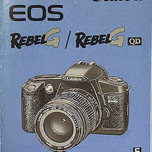 May include: A blue and white instruction manual for the Canon EOS Rebel G and Rebel G QD cameras. The cover features a black and silver Canon EOS Rebel G camera with a lens attached.