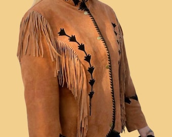 May include: A brown suede jacket with black fringe and embroidery. The jacket has a stand-up collar and a button closure.
