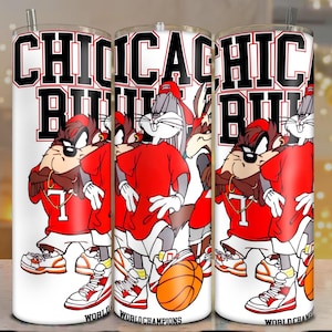 May include: Three white tumblers with a red, black, and white cartoon design. The tumblers feature Bugs Bunny and Taz from Looney Tunes wearing basketball uniforms with the text "Chicago Bulls" and "World Champions".