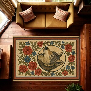 May include: Rectangular beige rug featuring a detailed illustration of a wolf's head looking up, surrounded by red roses, blue flowers, and green leaves. The rug has a brown border and is placed on a wooden floor.