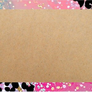 May include: A rectangular kraft paper card featuring blue balloons, star and heart shapes, and gift boxes in the lower left corner. The card is framed by a colourful border with pink, blue, gold, and black accents.