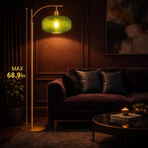 May include: A gold-colored floor lamp with a green glass shade. The shade has a textured pattern and is lit from within. The lamp's maximum height is 68.9 inches. The lamp is in a living room setting with a sofa and coffee table.