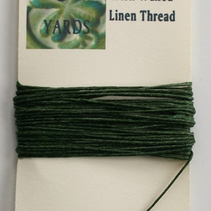May include: A spool of 4-ply Irish waxed linen thread in dark green, with a label that reads "5 yards" and "4-ply Irish Waxed Linen Thread".