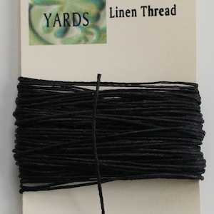 May include: A spool of black 4-ply Irish waxed linen thread, with a label that reads "10 YARDS".
