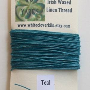 May include: Teal 4-ply Irish waxed linen thread, 10 yards, on a white card with the website www.whitecloverkiln.etsy.com printed on it.