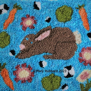 May include: A brown bunny rabbit with pink ears is surrounded by green, orange, and pink shapes on a blue background. The text "Mary Hubbard 2023" is in the lower center of the image.