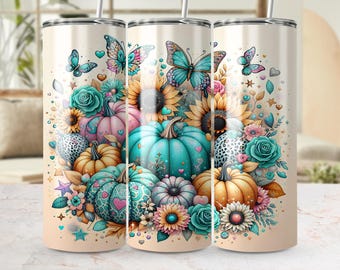 May include: A floral tumbler featuring a design of pumpkins, sunflowers, butterflies, and roses in shades of teal, pink, and orange. The tumbler has a cream-colored background and a silver straw.