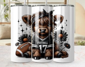 May include: A white tumbler featuring a cartoon Highland cow wearing a football jersey with the number 17. The cow is surrounded by black flowers, a football, and star accents. The word "FOOTBALL" is on the jersey.
