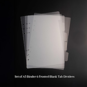 May include: A set of six frosted A5 binder tab dividers. Each translucent divider has pre-punched holes for binding and a tab for labeling. The image text reads: "Set of A5 Binder 6 Frosted Blank Tab Dividers."