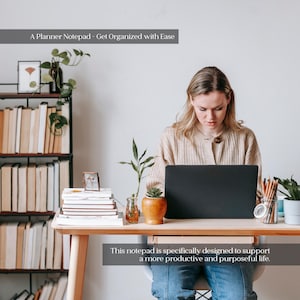 May include: A woman working on a laptop at a wooden desk. The desk has a stack of books, a small potted plant, and a pencil holder. The text on the image says, "A Planner Notepad - Get Organized with Ease" and "This notepad is specifically designed to support a more productive and purposeful life."