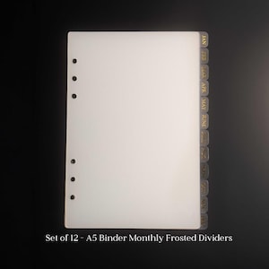 May include: A set of 12 A5 binder monthly frosted dividers. The dividers are white with gold lettering indicating the months of the year. The text "Set of 12 - A5 Binder Monthly Frosted Dividers" is at the bottom of the image.
