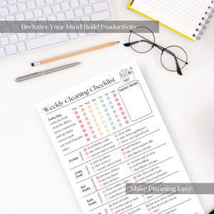 May include: A white printed weekly cleaning checklist with colorful checkboxes, a pencil, a pen, and round glasses. The text "Declutter Your Mind! Build Productivity" and "Make Planning Easy!" are visible. The checklist includes tasks for each room.