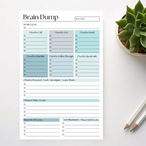 May include: A white Brain Dump notepad with sections for tasks like calls, texts, and emails. The notepad has a teal and gray color scheme, with the title at the top. A succulent plant and pencils are in the background.