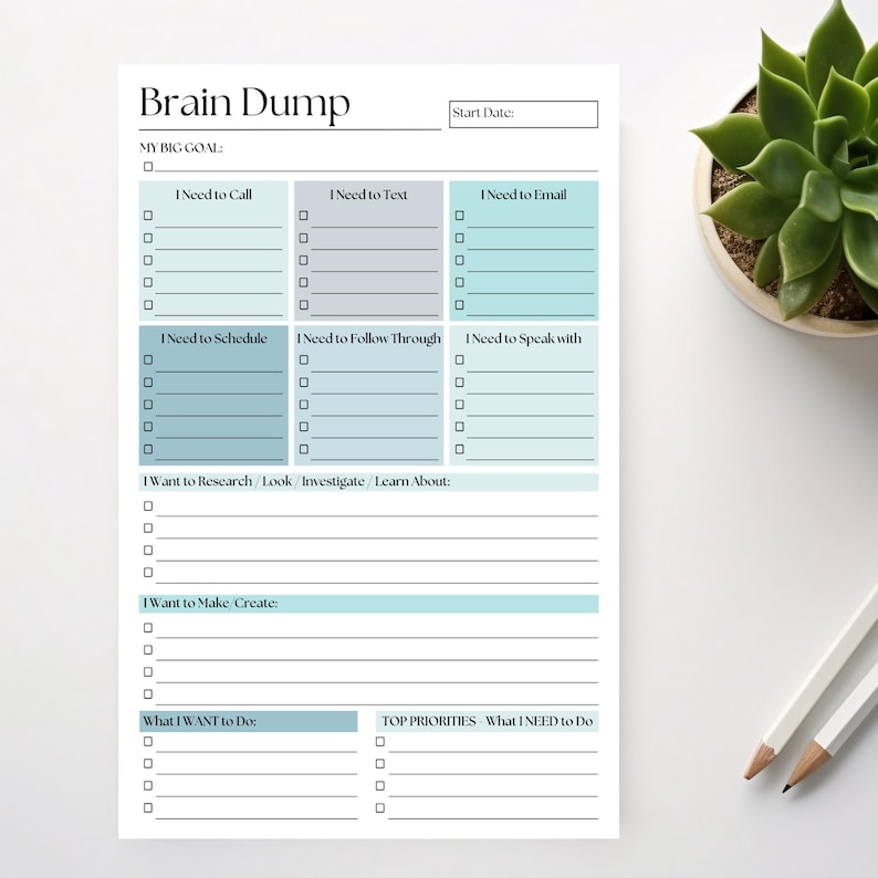 May include: A white Brain Dump notepad with sections for tasks like calls, texts, and emails. The notepad has a teal and gray color scheme, with the title at the top. A succulent plant and pencils are in the background.