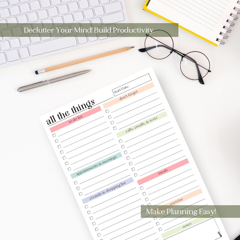 May include: A white notepad with the text "all the things" and sections for to-do lists, appointments, and errands. The notepad is on a white surface with a keyboard, pen, pencil, and glasses. Text on the notepad includes "Make Planning Easy!"