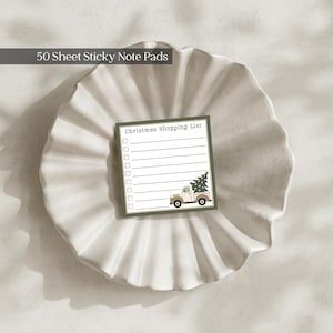 May include: A square sticky note pad with 50 sheets, featuring the text Christmas Shopping List, a column of checkboxes, and a graphic of a beige pickup truck carrying a green Christmas tree on a dark green border background.