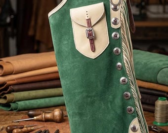 May include: Green and cream leather chaps with a pocket, silver star-shaped buttons, and fringe. The chaps feature a shamrock design and are likely for horseback riding or Western wear. The leather appears to be suede.