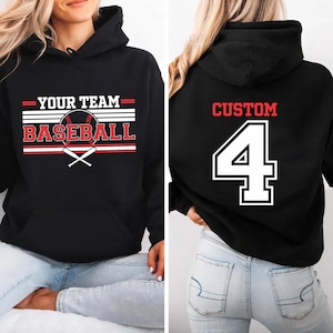 May include: Black baseball hoodie with the text "YOUR TEAM BASEBALL" in red and white. The front design includes a baseball and crossed bats. The back of the hoodie features the word "CUSTOM" and the number "4" in a white outline.