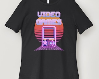 May include: Black t-shirt with a retro-style graphic of a video game console and the text "VIDEO GAMES" in pink and purple.