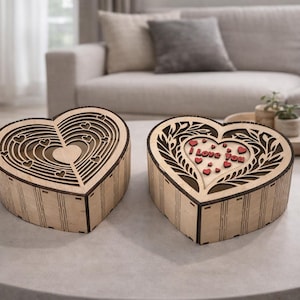 May include: Two heart-shaped wooden boxes. One box has a layered design with small hearts. The other box has the words "I Love You" in red, with small red hearts. Both boxes are on a round table.