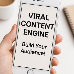 May include: A white smartphone displays the text "VIRAL CONTENT ENGINE" and "Build Your Audience!" in black. The phone is held in a hand, with a cup of coffee and a notepad visible in the background.