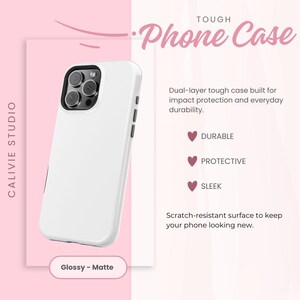 May include: A white phone case with a black camera cutout, labeled "Tough Phone Case." The case is described as durable, protective, and sleek, with a scratch-resistant surface. The text "Glossy - Matte" is also visible.