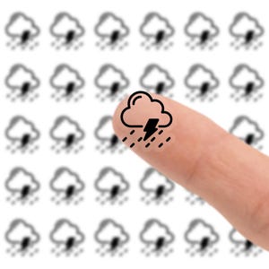 May include: A close-up of a finger pointing at a black and white weather icon. The icon depicts a cloud with a lightning bolt and rain. The background features a grid of blurred weather icons.