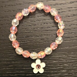 Pink beaded bracelet with flower charm
