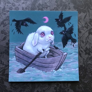 May include: A white rabbit with pink eyes sits in a small wooden boat, rowing with a wooden oar. The boat is floating on a dark blue sea with a crescent moon in the sky. Three black crows fly overhead.