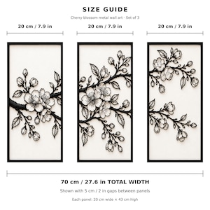 May include: A set of three rectangular metal wall art panels featuring black cherry blossom branches on a white background. Each panel measures 7.9 inches wide by 16.9 inches high, with a total width of 27.6 inches including 2-inch gaps.