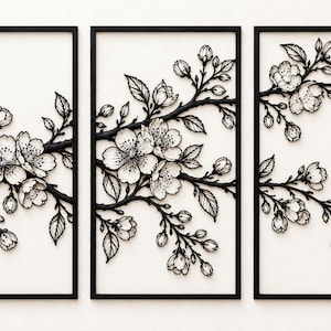 May include: A triptych wall art set featuring three rectangular black frames containing white panels. Each panel displays a raised, black-and-white relief sculpture of cherry blossom branches with detailed flowers, buds, and leaves.