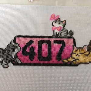 May include: A pixel art design featuring three cats and the number 407. The number is displayed on a pink rectangle. One cat is perched on top, another is stretching, and the third is walking.