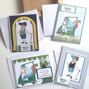 May include: Four humorous golf-themed greeting cards with white envelopes. Each card features a cartoon illustration of a golfer or golf cart. The cards have text that reads "Going Play 'Round?" and "To Golf or Not to Golf... what a Stupid Question."