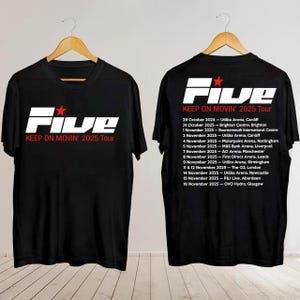 May include: Black t-shirt featuring the text "Five" with a red star and "KEEP ON MOVIN' 2025 Tour" in white. The back of the shirt lists tour dates and locations. A concert merchandise item.