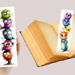 May include: Two whimsical bookmarks featuring cartoon birds. One bookmark is held by a hand, the other is placed in an open book. The birds are in various colors, including green, purple, blue, pink, orange, and yellow. The bookmarks are white with a glossy finish.