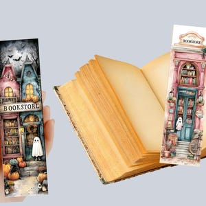 May include: Watercolor bookmarks featuring a bookstore theme. One bookmark is held in a hand, showcasing a spooky bookstore scene with pumpkins and a ghost. The other bookmark is placed in an open book. The bookmarks have the word "BOOKSTORE" on them.