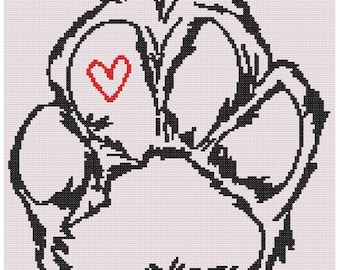 May include: Cross stitch pattern of a dog paw with a red heart in the center. The paw print is black, and the background is light pink. The design size is 148 x 164 stitches. The text at the top says "Dog Paw with Heart Cross Stitch Pattern".