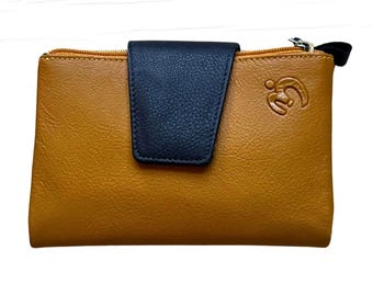 May include: Mustard yellow wallet with a navy blue flap closure. The wallet has a zipper closure and a small logo on the front. The wallet is rectangular in shape and appears to be made of leather.